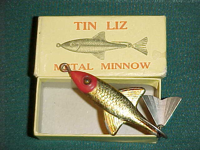 All metal Fred Arbogast Big Tin Liz jigging (?) lure with glass eyes,  hanging metal tail and some paint wear marked #2 - AAA Auction and Realty